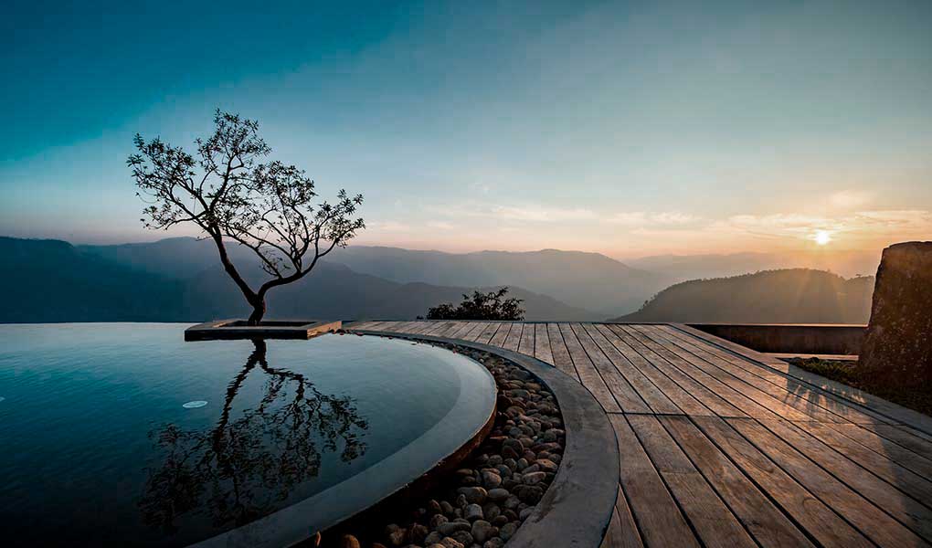 Vistas desde la piscina exterior al atardecer en Prakriti Shakti en India